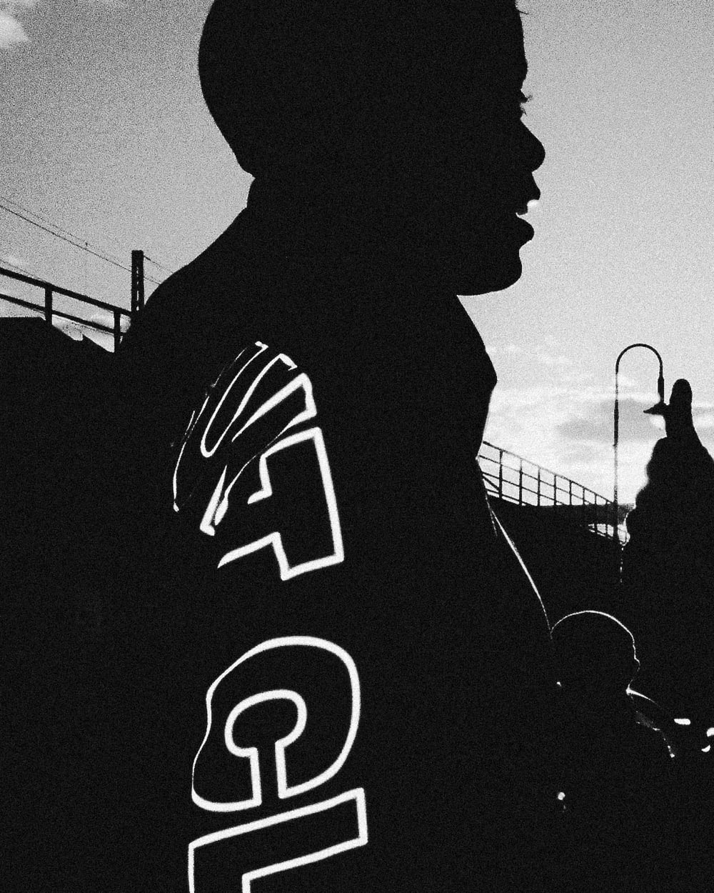 Reflective lettering on the OG Trackjacket sleeve in an outdoor silhouette