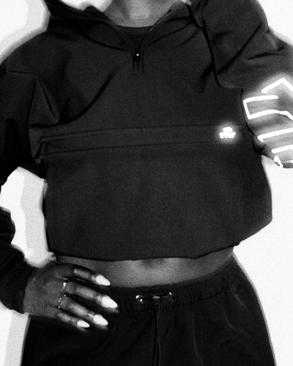 Close view of the black OG Trackjacket front pocket and reflective logo