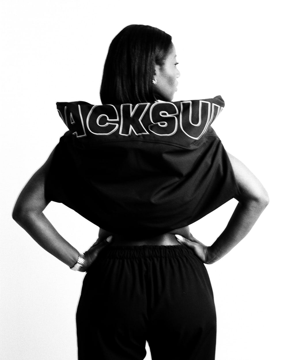Rear view of the black OG Trackjacket and upper Trackpants worn together